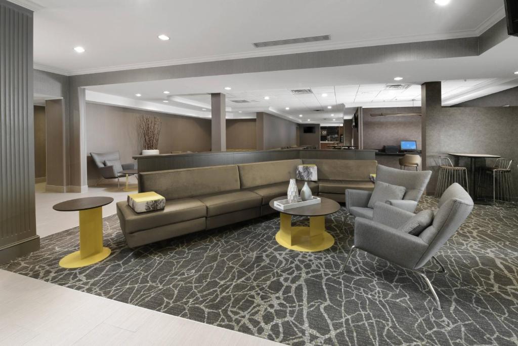 a lobby with a couch and two chairs and tables at SpringHill Suites Dallas Addison/Quorum Drive in Dallas