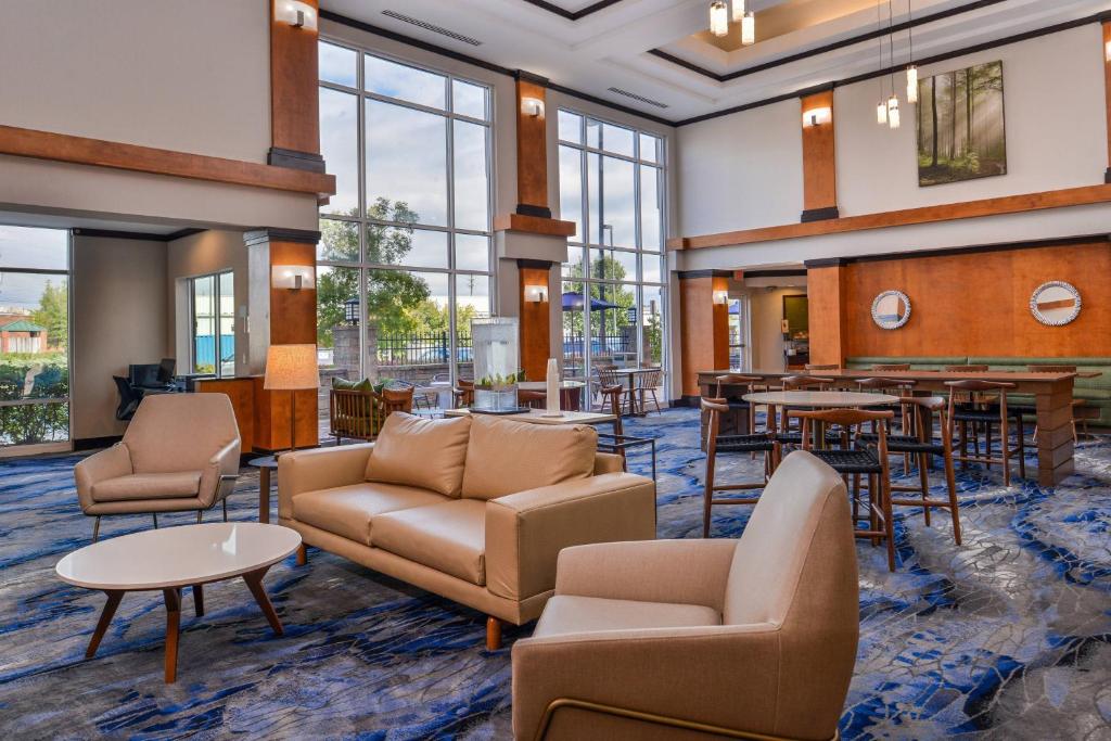 a lobby with furniture and tables and windows at Fairfield Inn and Suites by Marriott Birmingham Pelham/I-65 in Pelham