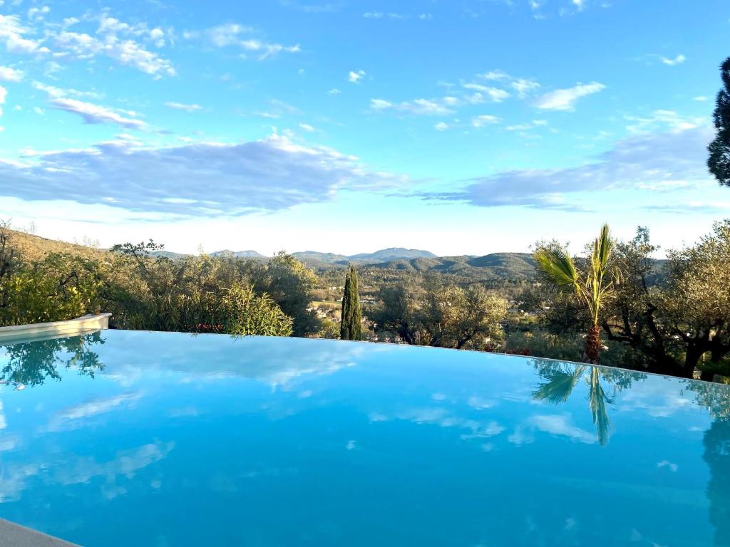a swimming pool with a view of the mountains at Les Lodges de Saint Cassien in Montauroux