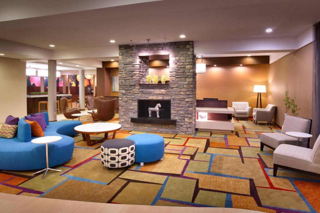 a lobby with a fireplace and couches and chairs at Fairfield Inn & Suites by Marriott Salt Lake City Downtown in Salt Lake City