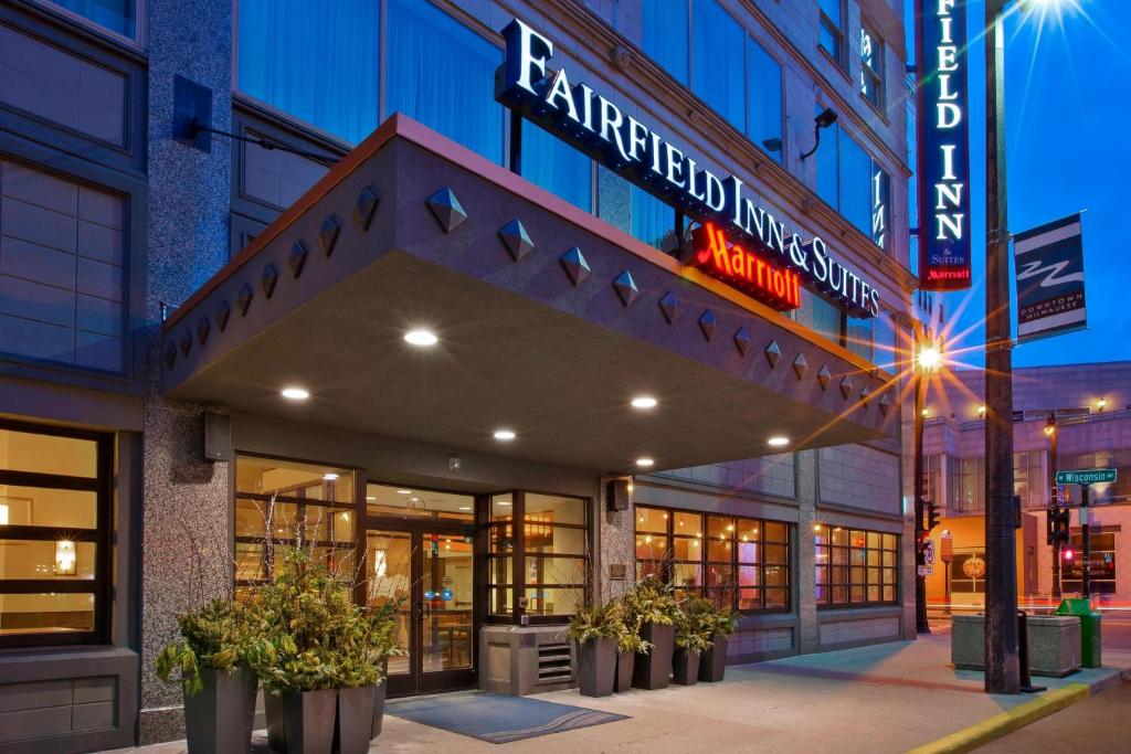 a store front with potted plants in front of a building at Fairfield Inn & Suites by Marriott Milwaukee Downtown in Milwaukee