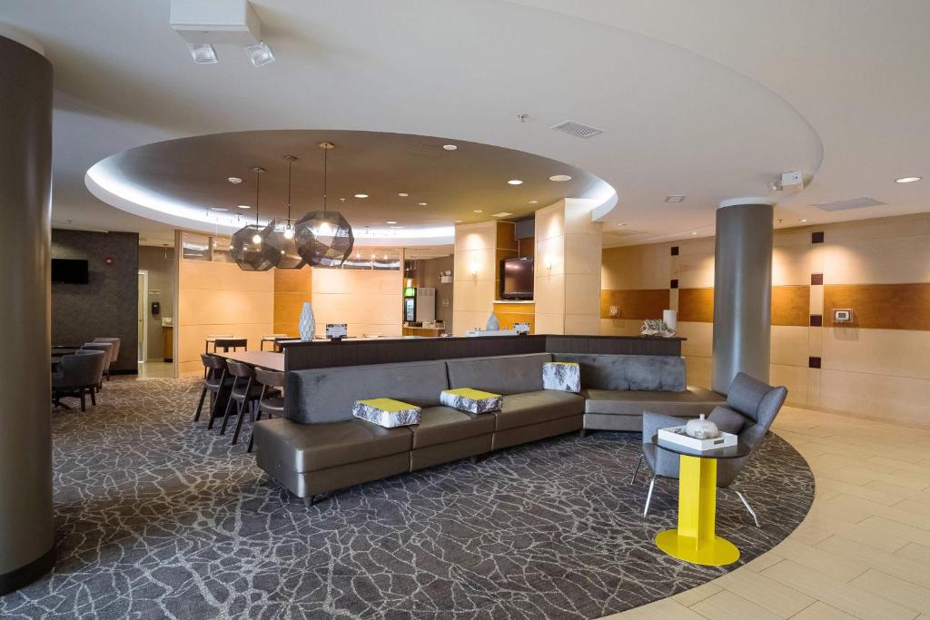 a living room with a couch and a dining room at SpringHill Suites by Marriott Winston-Salem Hanes Mall in Winston-Salem