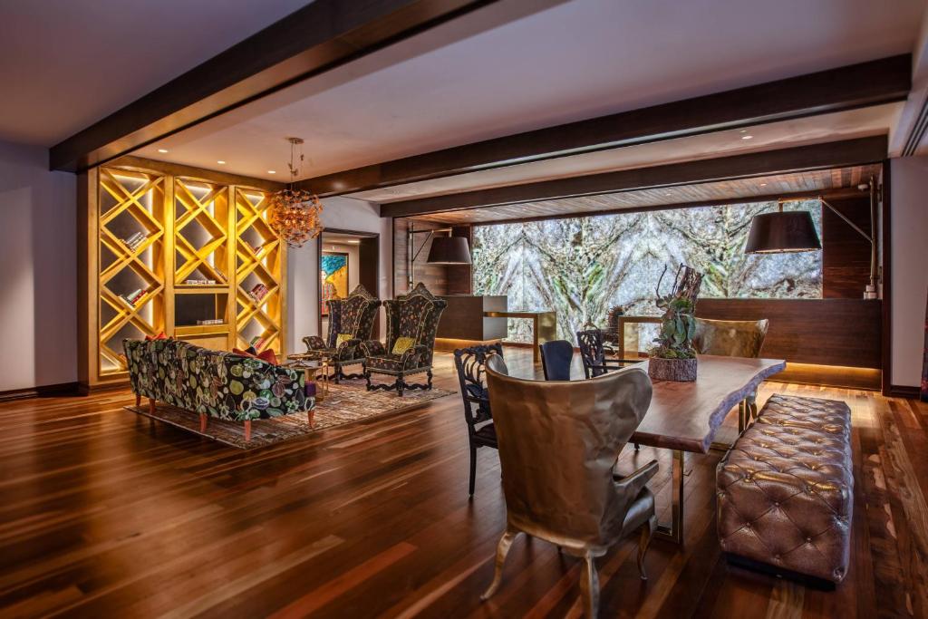 a living room with a table and chairs at Grand Bohemian Hotel Mountain Brook, Autograph Collection in Birmingham