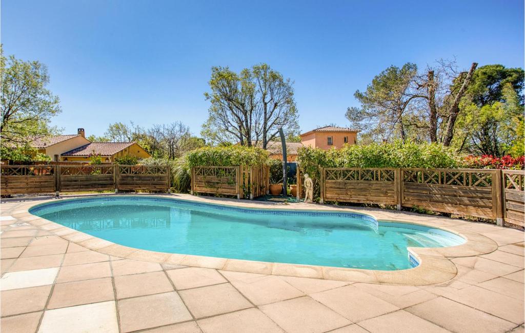 a swimming pool in a yard with a fence at Gorgeous Apartment In Le Luc With Wifi in Le Luc