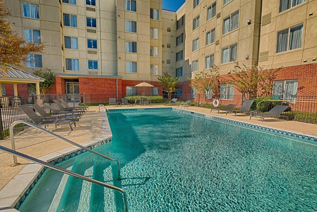 a swimming pool in front of a building at Residence Inn Fort Worth Alliance Airport in Roanoke