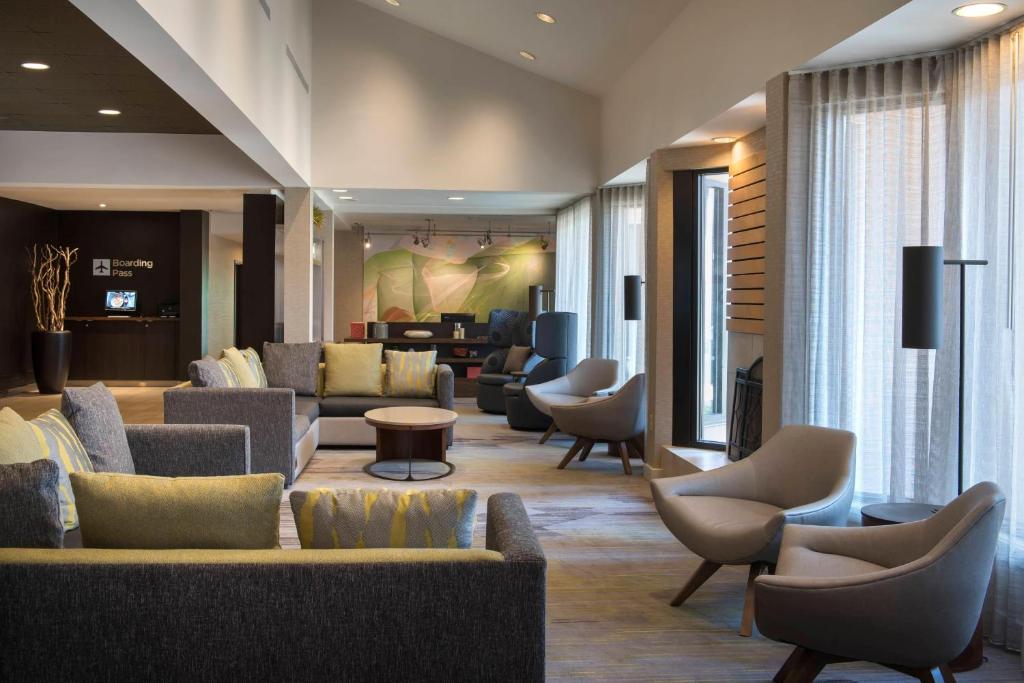a hotel lobby with couches and chairs at Courtyard by Marriott Boston Norwood/Canton in Norwood