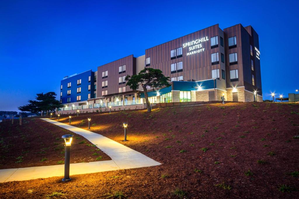 a building at night with lights in front of it at SpringHill Suites by Marriott The Dunes On Monterey Bay in Marina