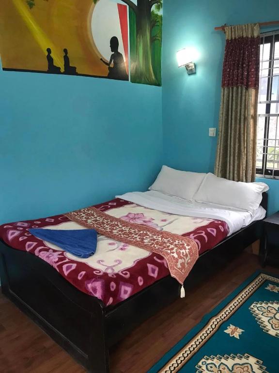 Postel nebo postele na pokoji v ubytování GAUTAM GARDEN GUEST HOUSE