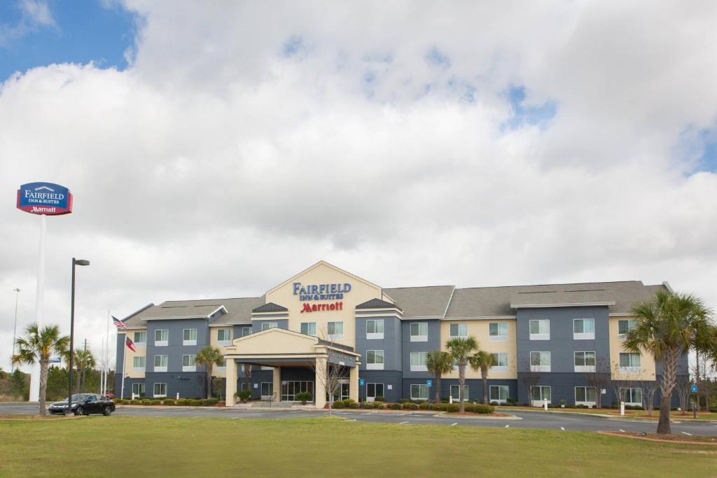 a rendering of the exterior of a hotel with a parking lot at Fairfield Inn & Suites by Marriott Cordele in Cordele