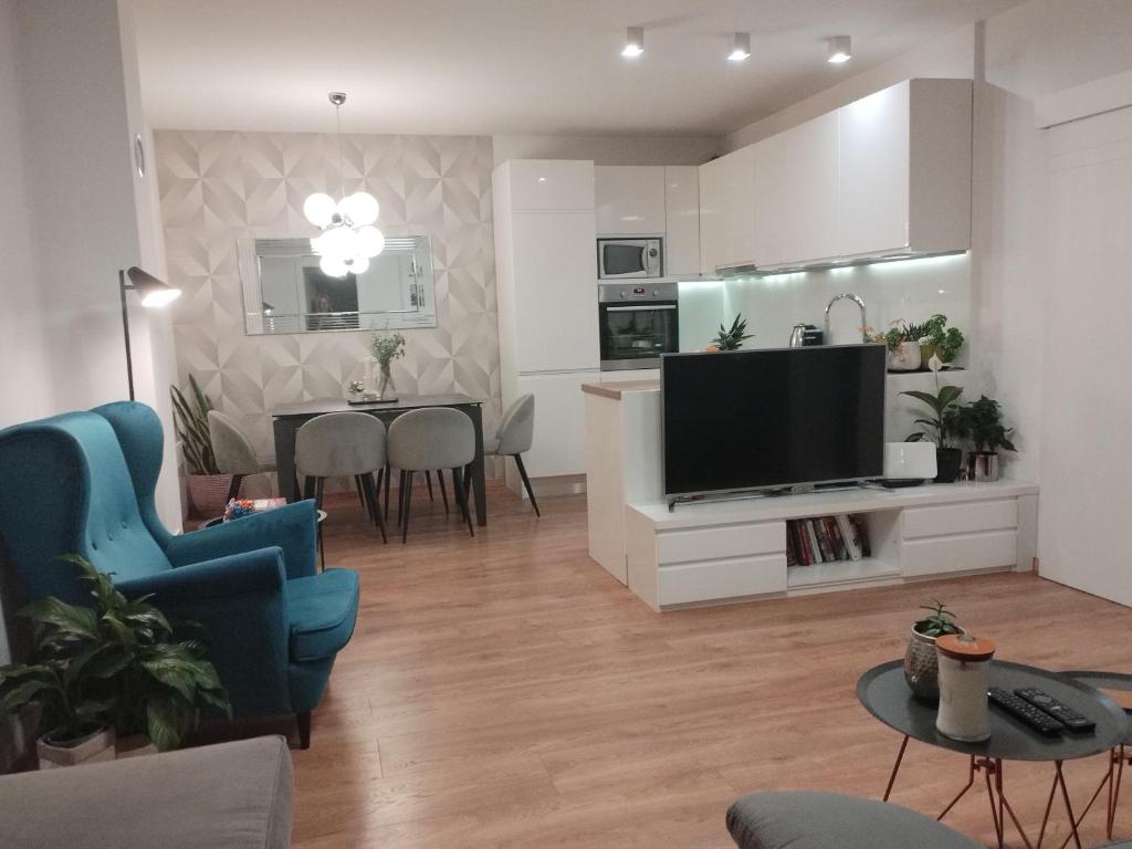 a living room with a television and a dining room at Luxury apartment near the beach in Makarska