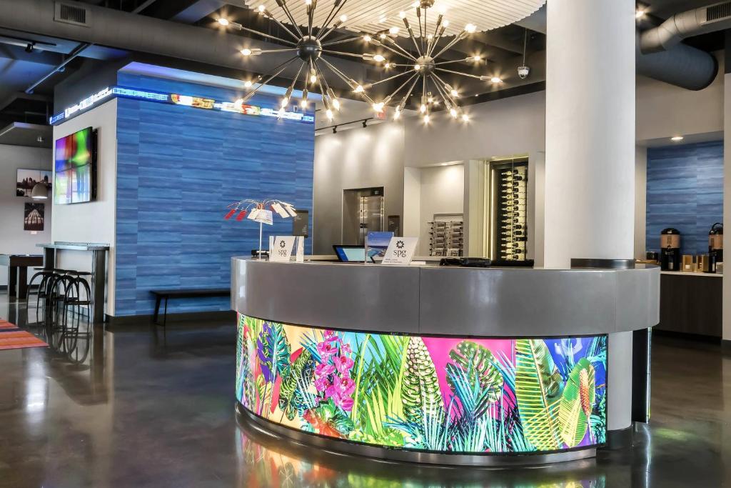 a lobby with a colorful counter in a room at Aloft Newport on the Levee in Newport