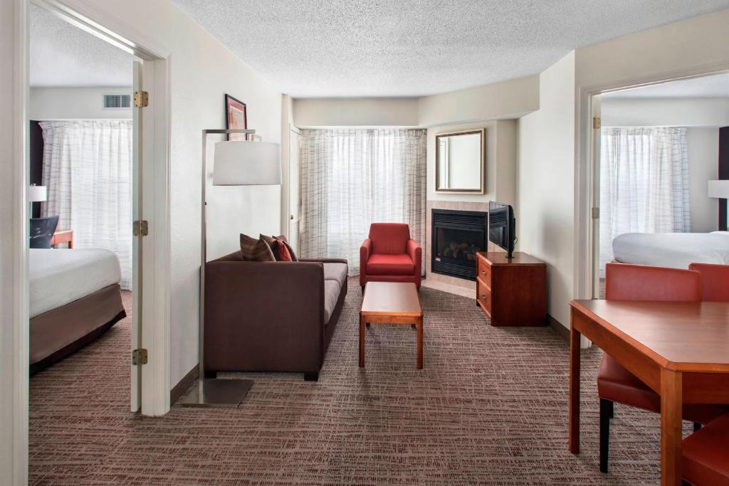 a hotel room with a bedroom with a bed and a desk at Residence Inn by Marriott Somerset in Somerset