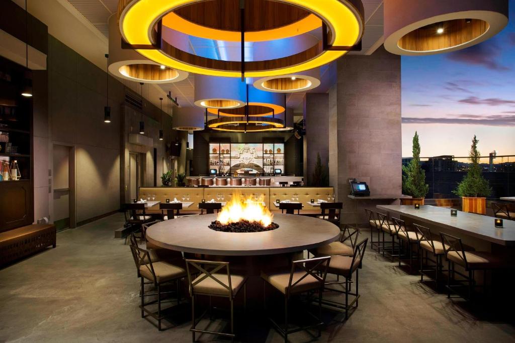 a restaurant with a fire pit and tables and chairs at Courtyard by Marriott San Diego Gaslamp/Convention Center in San Diego