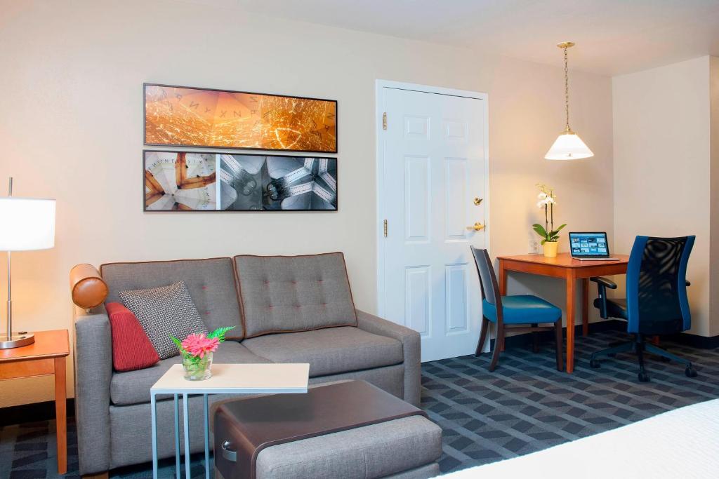 a living room with a couch and a table at TownePlace Suites by Marriott Indianapolis - Keystone in Indianapolis