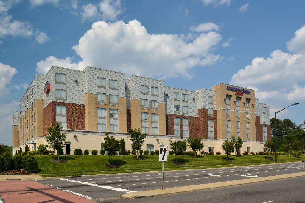 a large building on the side of a street at SpringHill Suites by Marriott Charlotte Ballantyne in Charlotte