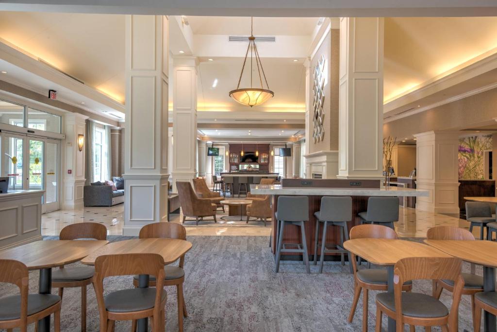 a lobby with tables and chairs in a building at Courtyard Chapel Hill in Chapel Hill