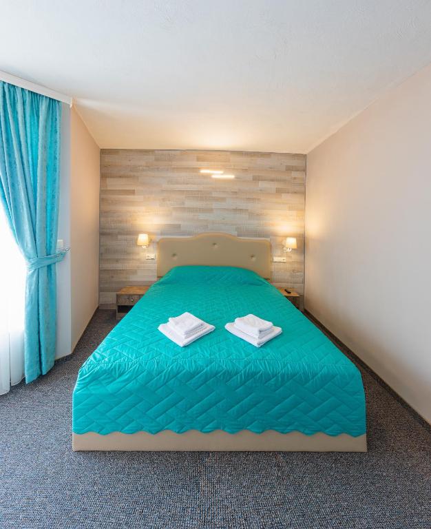 Postel nebo postele na pokoji v ubytování Lecardo Hotel