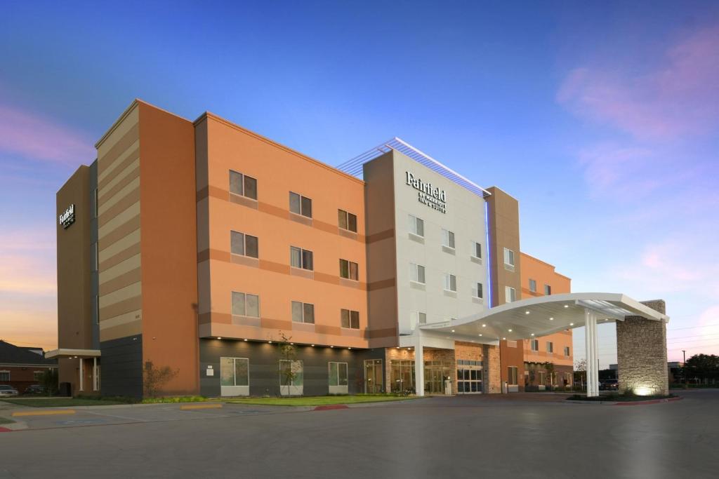 a building with a parking lot in front of it at Fairfield by Marriott Inn & Suites Dallas East in Dallas