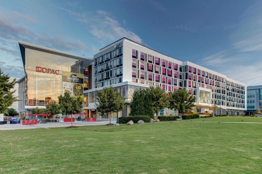 a large building with a lawn in front of it at Aloft Durham Downtown in Durham