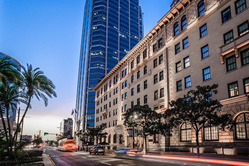 a city street with tall buildings and palm trees at The Guild Hotel, a Marriott Tribute Portfolio Hotel in San Diego