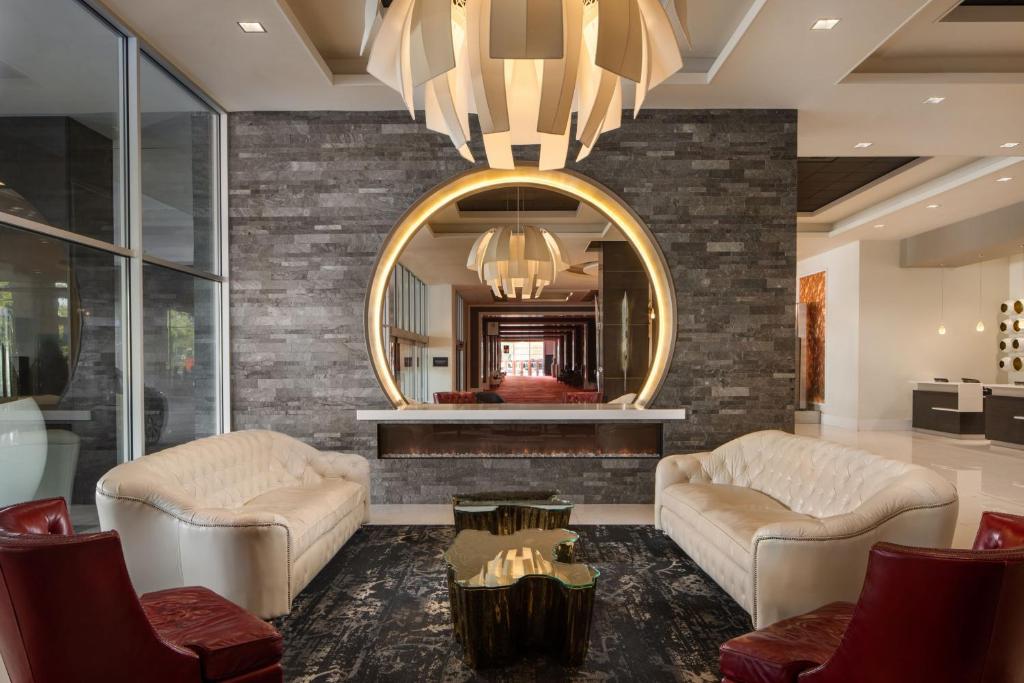 a living room with two couches and a mirror at The Davenport Grand, Autograph Collection in Spokane