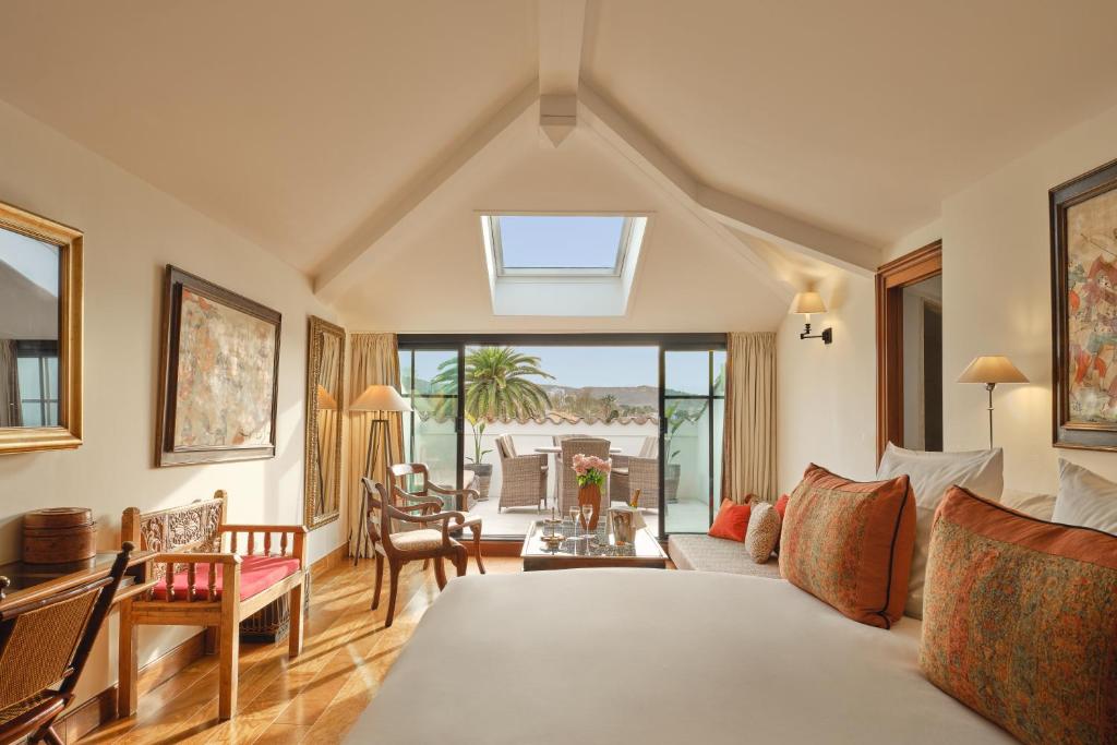 a bedroom with a bed and a living room at Pan Dei Palais in Saint-Tropez