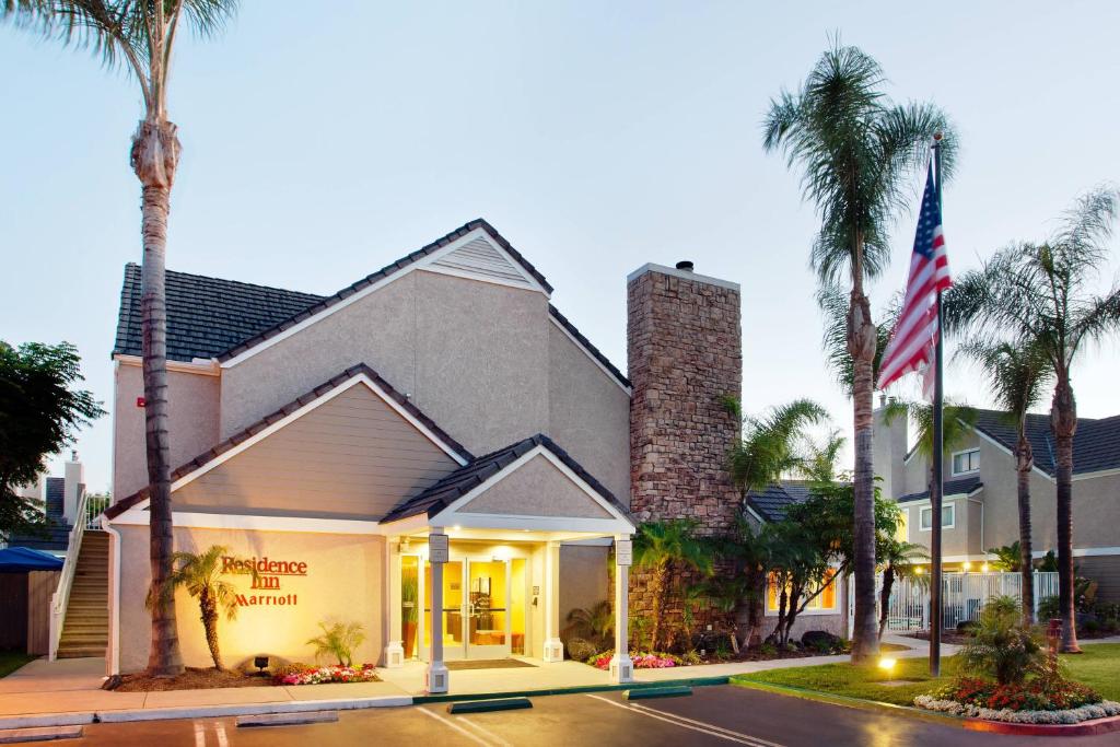 a building with palm trees in front of it at Residence Inn Irvine Spectrum in Irvine