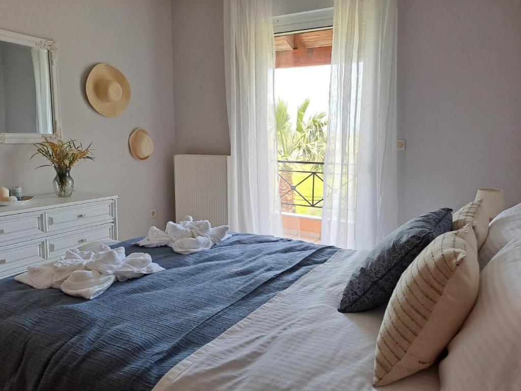 um quarto com uma cama grande e uma janela em Corfu Lake House em Kanoni