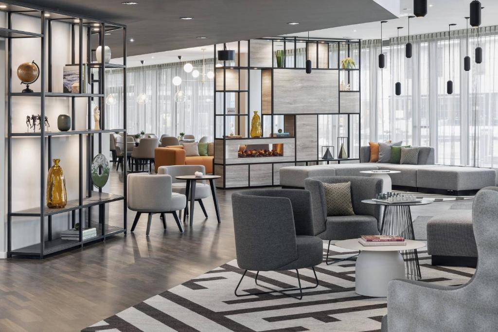 a lobby with chairs and tables in a building at Residence Inn by Marriott Munich Ostbahnhof in Munich