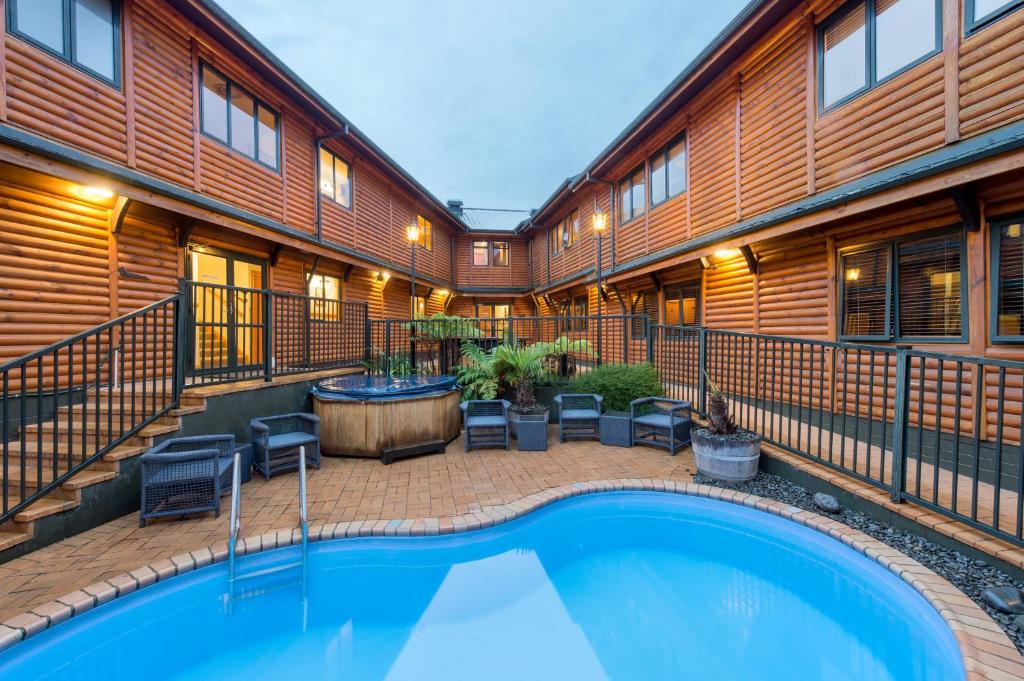 an indoor swimming pool in the middle of a building at Lakefront Lodge Taupo in Taupo