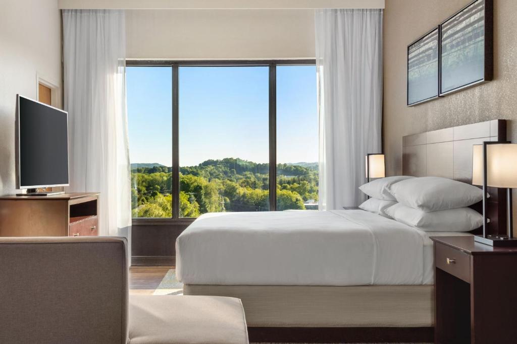 a bedroom with a bed and a large window at Delta Hotels by Marriott Bristol in Bristol