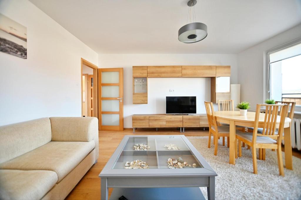 a living room with a couch and a table at Horyzont by 3City Rentals in Gdynia