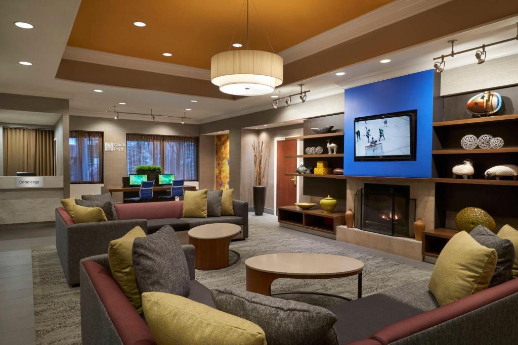 a large living room with couches and a fireplace at Courtyard by Marriott Toronto Downtown in Toronto