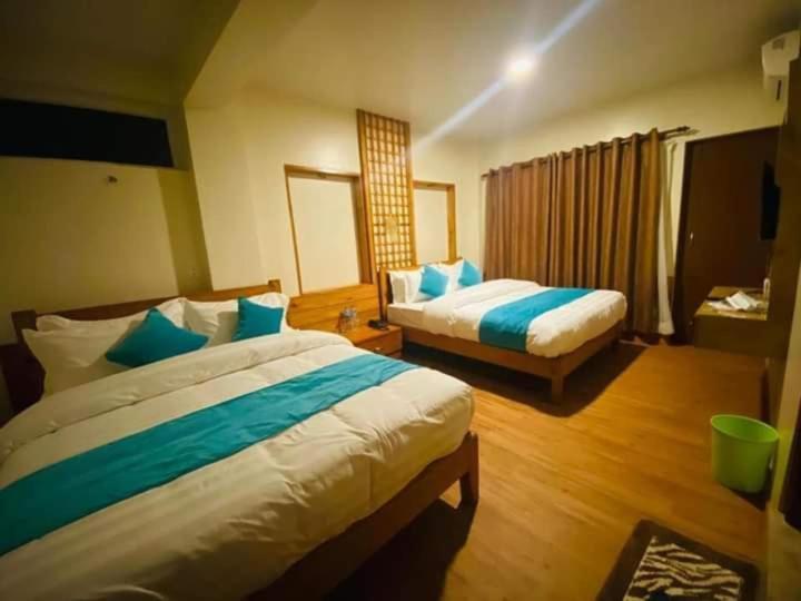 Postel nebo postele na pokoji v ubytování Hotel Himalayan Glacier