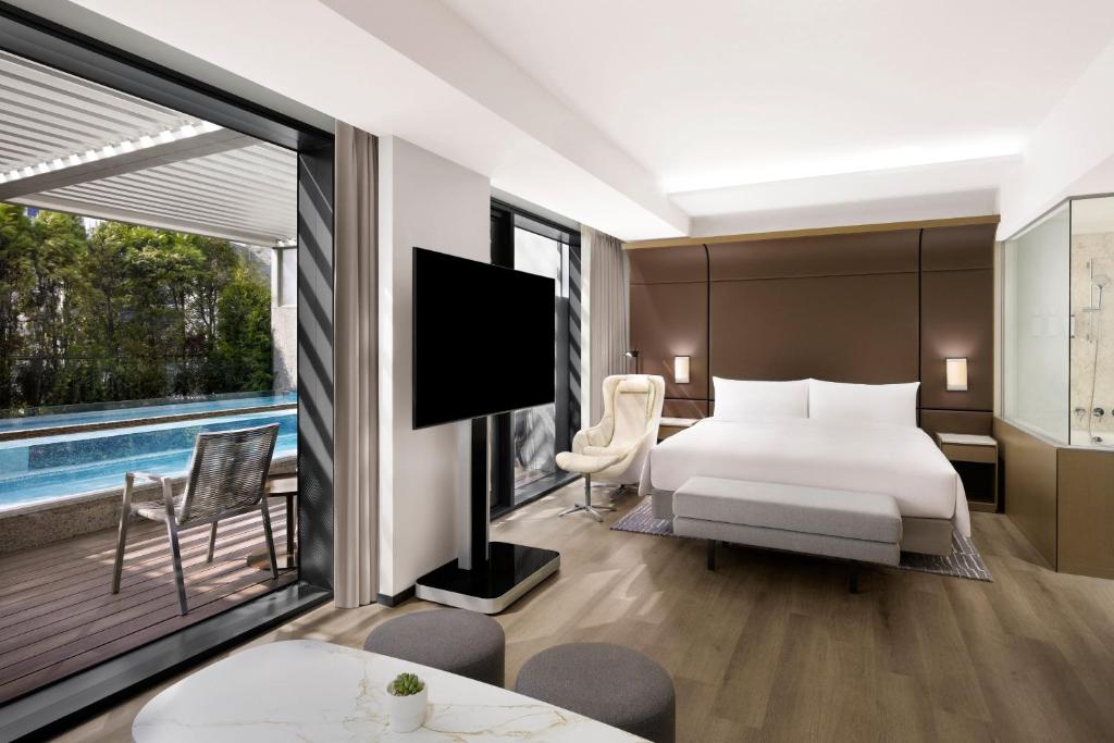 a hotel room with a bed and a large window at AC Hotel by Marriott Seoul Gangnam in Seoul