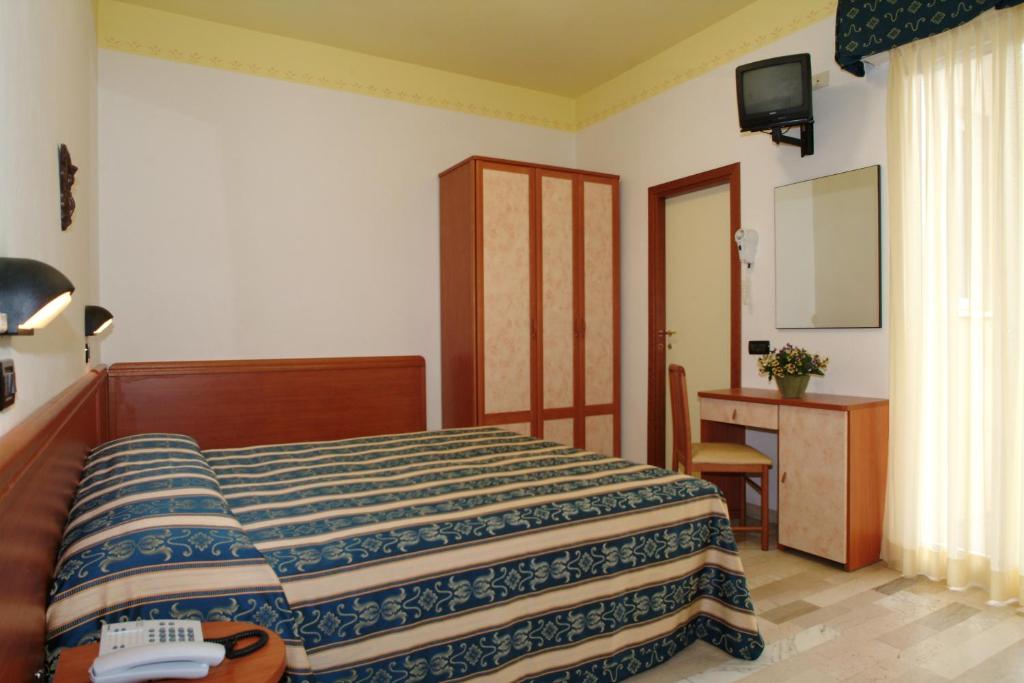 Postel nebo postele na pokoji v ubytování Hotel Grado