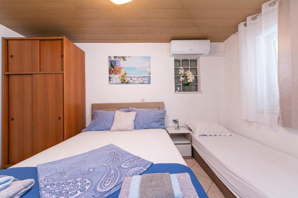 Postel nebo postele na pokoji v ubytování Apartmani Jakiruša