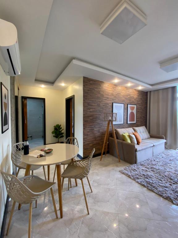 uma sala de estar com uma mesa e cadeiras e um sofá em Local 401 Apartment no Rio de Janeiro