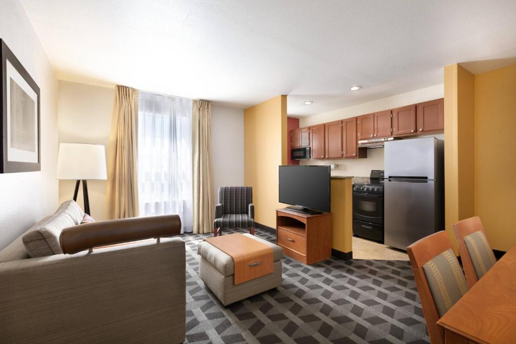 a living room with a couch and a kitchen at TownePlace Suites Gaithersburg in Gaithersburg