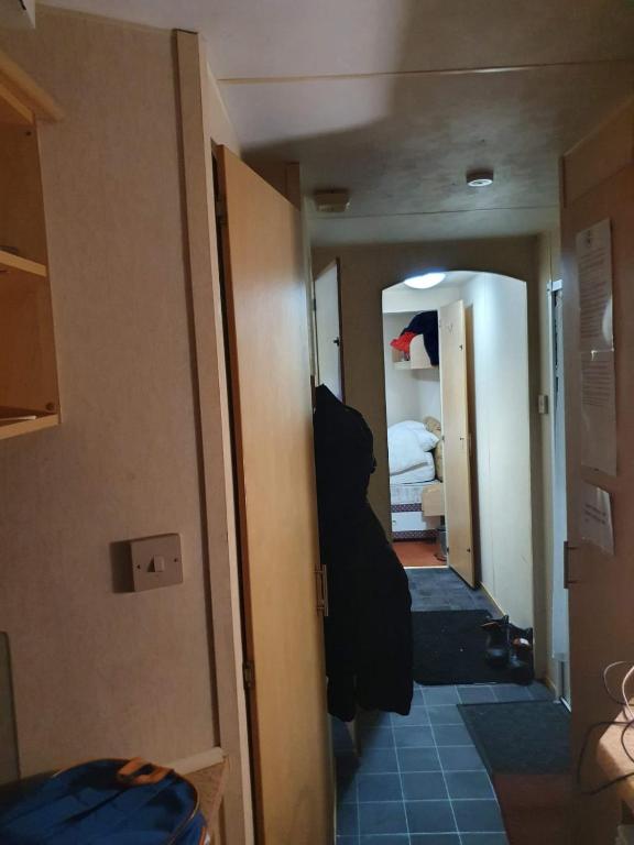 a room with a hallway with a room with a bed at R and B static Caravan in Skegness