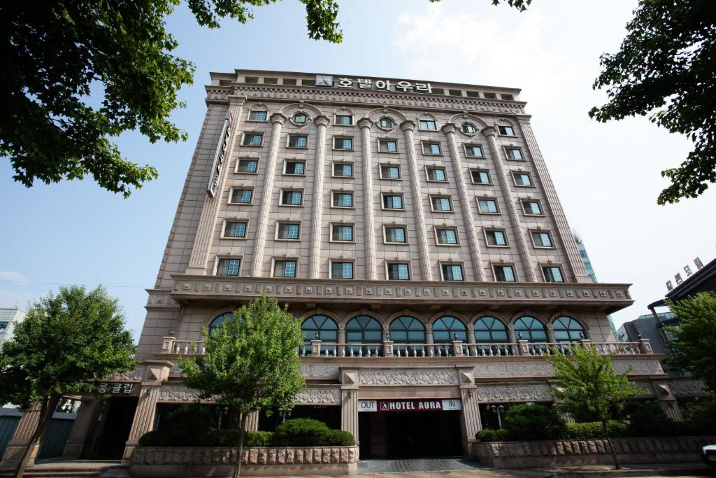 a tall building with a sign on it at Aura Hotel in Ansan