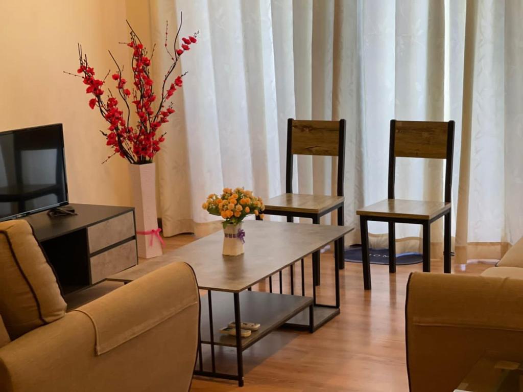 a living room with a table and two chairs and a tv at Newly Riverbank suites 408 in Kuching