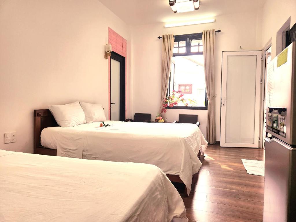 Postel nebo postele na pokoji v ubytování Anh Family Homestay