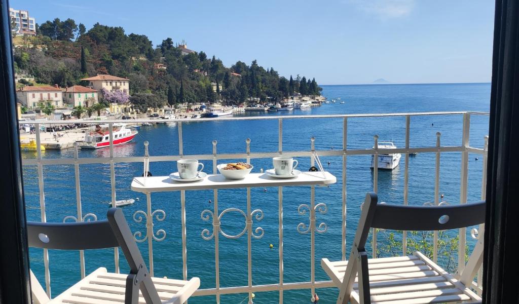 a table with two chairs and a view of the water at Beautiful seaside 2 bedroom apartment Babina in Rabac