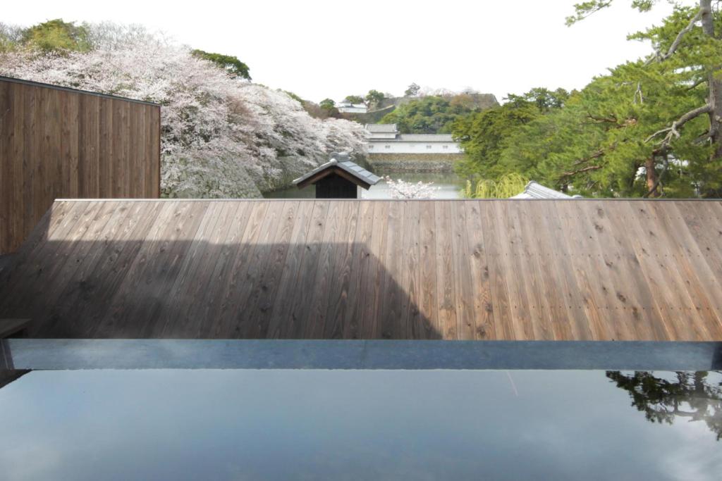 a wooden fence with a pool of water at Hikone Castle Resort & Spa in Hikone