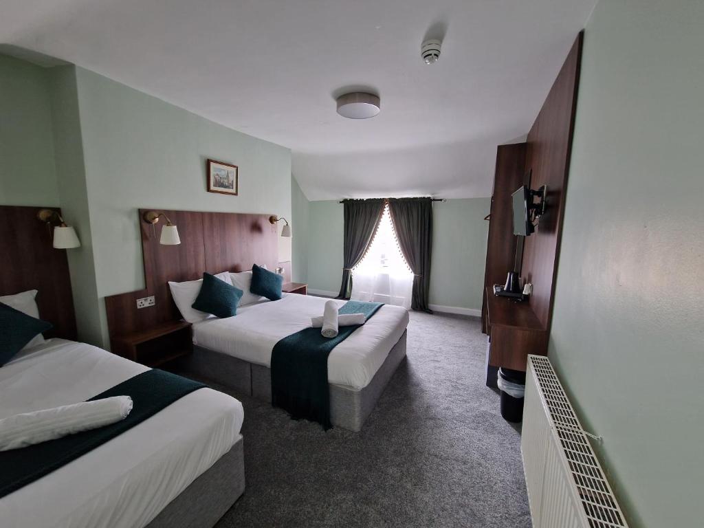 Postel nebo postele na pokoji v ubytování Lyndon Guesthouse