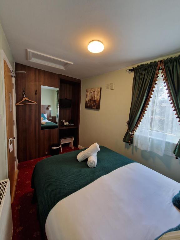 Postel nebo postele na pokoji v ubytování Lyndon Guesthouse