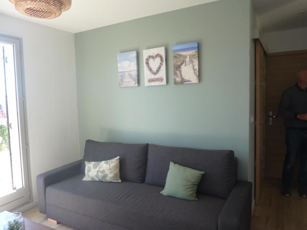 a gray couch in a living room with a window at Houlgate in Houlgate