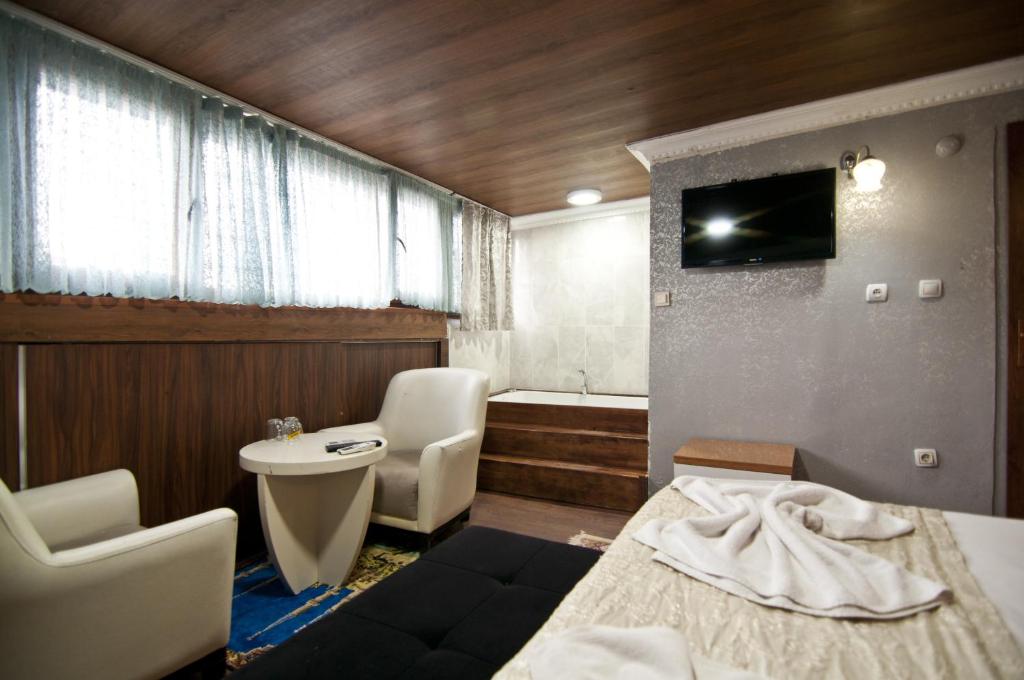 a bathroom with a bed and a sink and a toilet at The New Season Apart in Istanbul