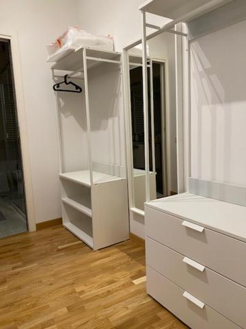 a white closet with white drawers and a mirror at Dimora Centro Storico Roma in Rome